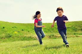 two children running outside having fun